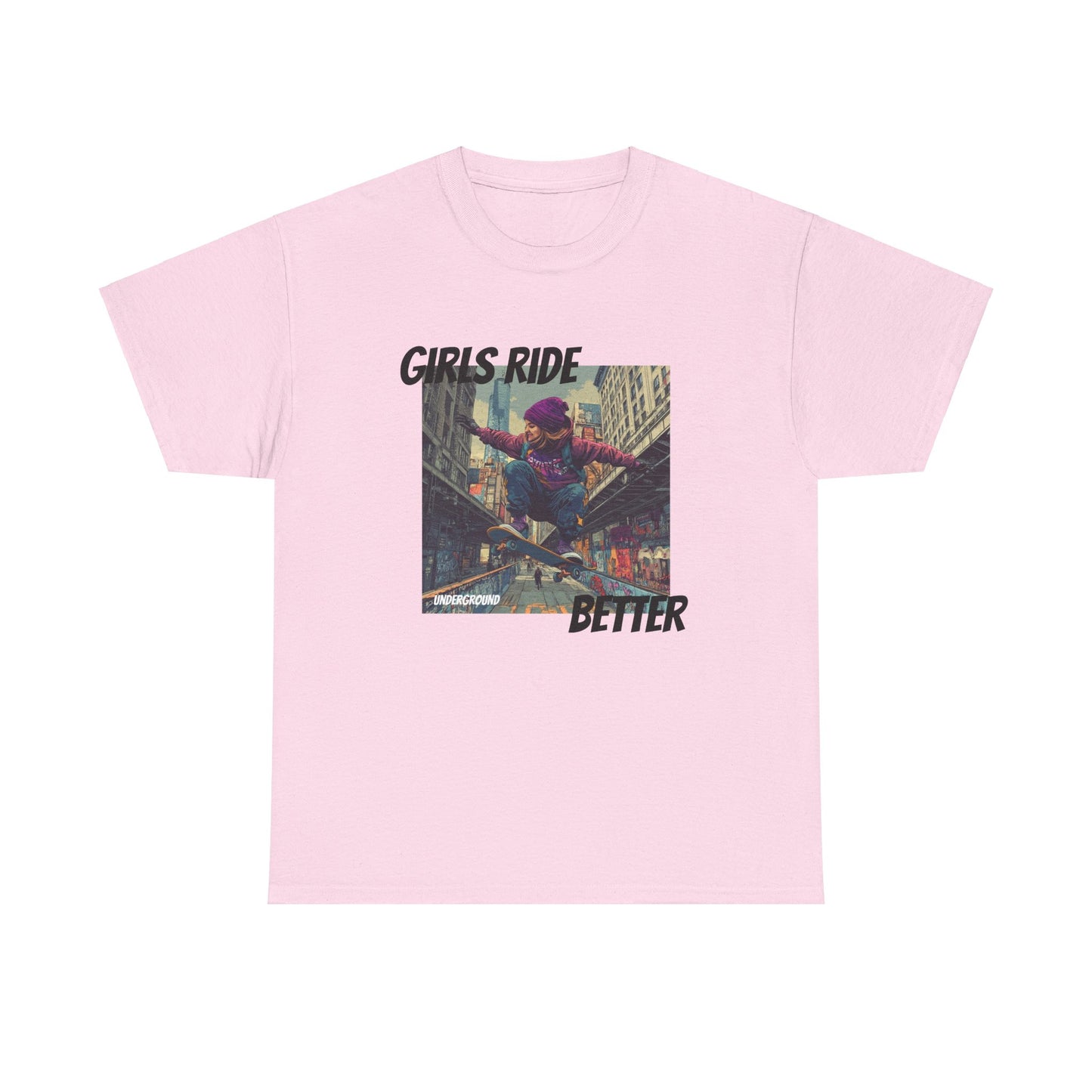 Pink Graphic T-shirt with an Image of a Gritty, colorful street-inspired artwork of a girl riding a skateboard, wearing a purple snow hat and a streetwear hoodie. Bold urban expression with the slogan "Girls Ride Better."