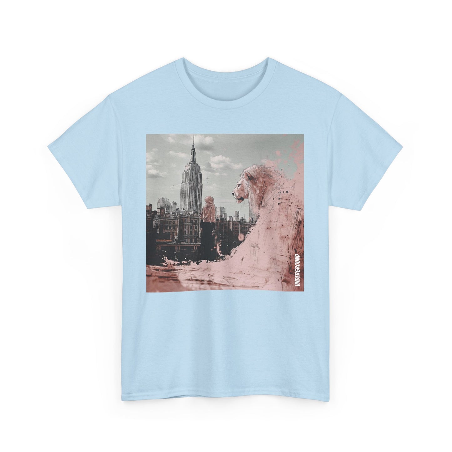 Light blue Graphic T-shirt of a Striking ink and pastel illustration of a woman standing before a city backdrop, gazing at a massive pink lion overlooking the skyline. A fusion of urban energy and surreal artistry.